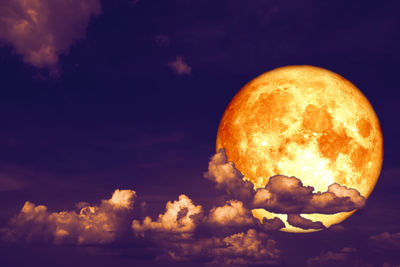 Low angle view of moon against sky at sunset