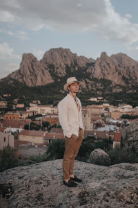 Full length of man standing on mountain against sky