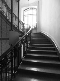 Spiral staircase of building to the window with light 