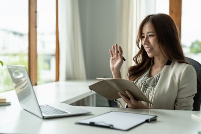 Businesswoman working at table