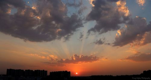 Silhouette buildings against sky during sunset