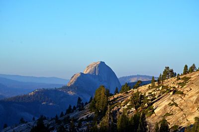 Scenic view of mountains against blue sky