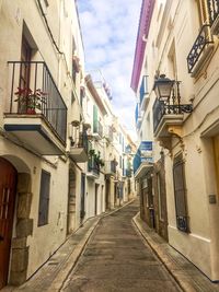 Alley amidst buildings against sky