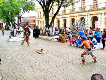 People sitting on street in city