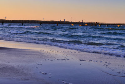 Scenic view of beach against sky during sunset