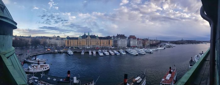 Panoramic view of cityscape against cloudy sky