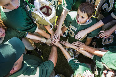 High angle view of american football players huddling on field