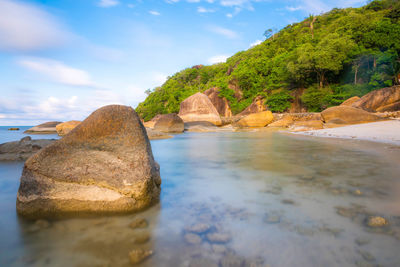 Rocks on beach against sky