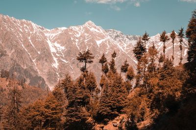 Scenic view of snow covered mountains against sky