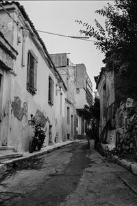 Street amidst buildings in city against sky