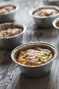 High angle view of baked eggs with spinach and parmesan cheese