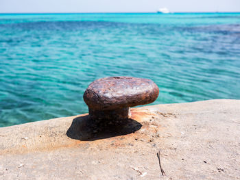 Close-up of rusty metal on beach
