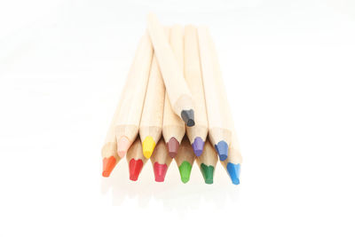 Close-up of multi colored pencils against white background