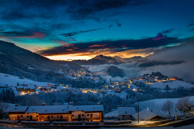 Mountain village after snowfall at sunset