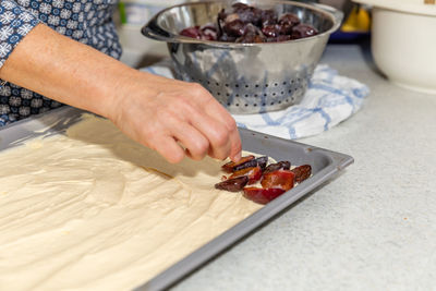 Midsection of man preparing food in kitchen