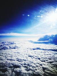 Scenic view of snow covered landscape against blue sky