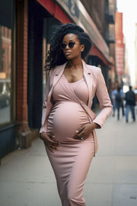 Portrait of young woman looking away while standing in city