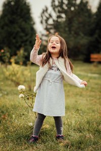 Full length of girl standing on field