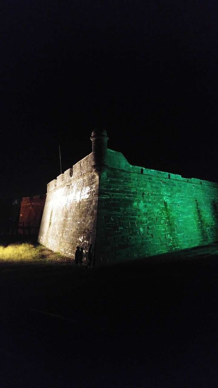 LOW ANGLE VIEW OF ILLUMINATED BUILDING AGAINST CLEAR SKY