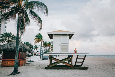 Lifeguard hut on beach against sky