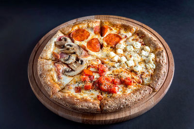High angle view of pizza on table against black background