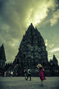 People at temple against building