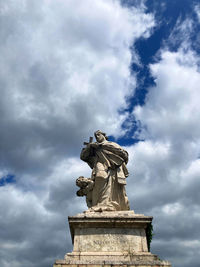 Low angle view of statue against cloudy sky