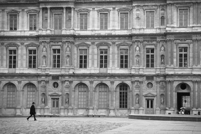 Man walking in front of building