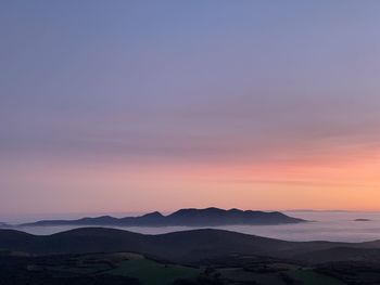 Scenic view of silhouette mountain against sky during sunset