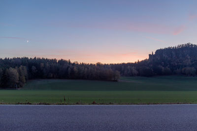 Scenic view of field against sky during sunset