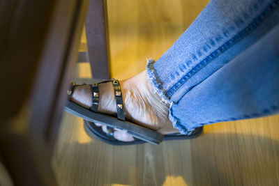 Low section of woman wearing canvas shoes