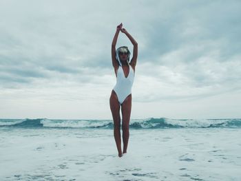 Woman jumping on beach