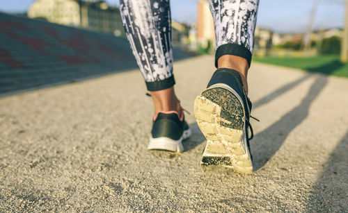 Low section of woman jogging at park