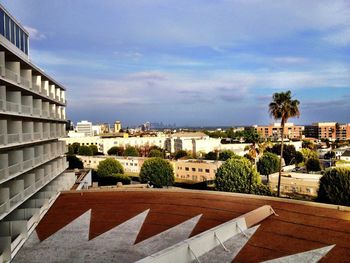 Buildings against cloudy sky
