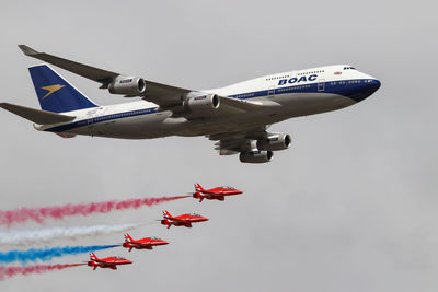 Low angle view of airplane flying against sky