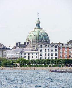 View of buildings at waterfront against sky