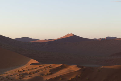 Scenic view of desert against sky during sunset