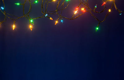 Low angle view of illuminated tree against sky at night