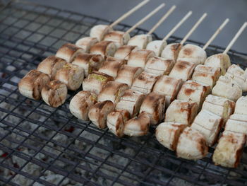 High angle view of banana slices in skewers on barbecue grill