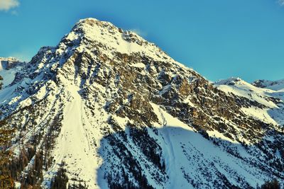 Scenic view of snowcapped mountains against clear blue sky