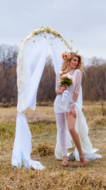 Full length of bride standing on field