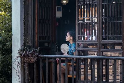 Woman looking through window