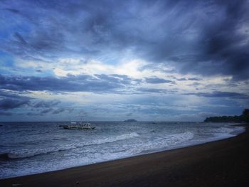 Scenic view of sea against cloudy sky