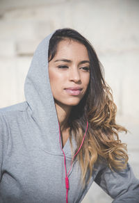 Portrait of beautiful young woman wearing hoodie