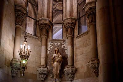 Low angle view of statue in illuminated church