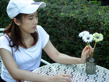 Woman looking at flowers outdoors