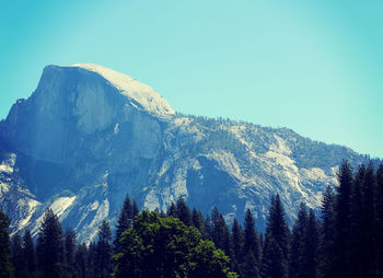 Low angle view of mountains against clear blue sky