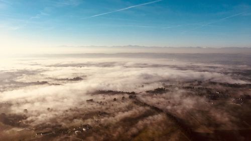 Aerial view of landscape against blue sky