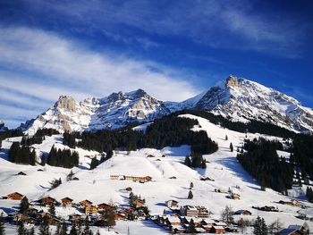 Scenic view of snow covered mountains against sky