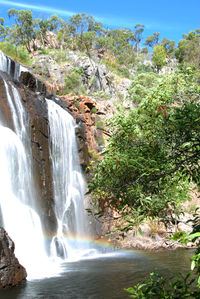 Low angle view of waterfall against sky